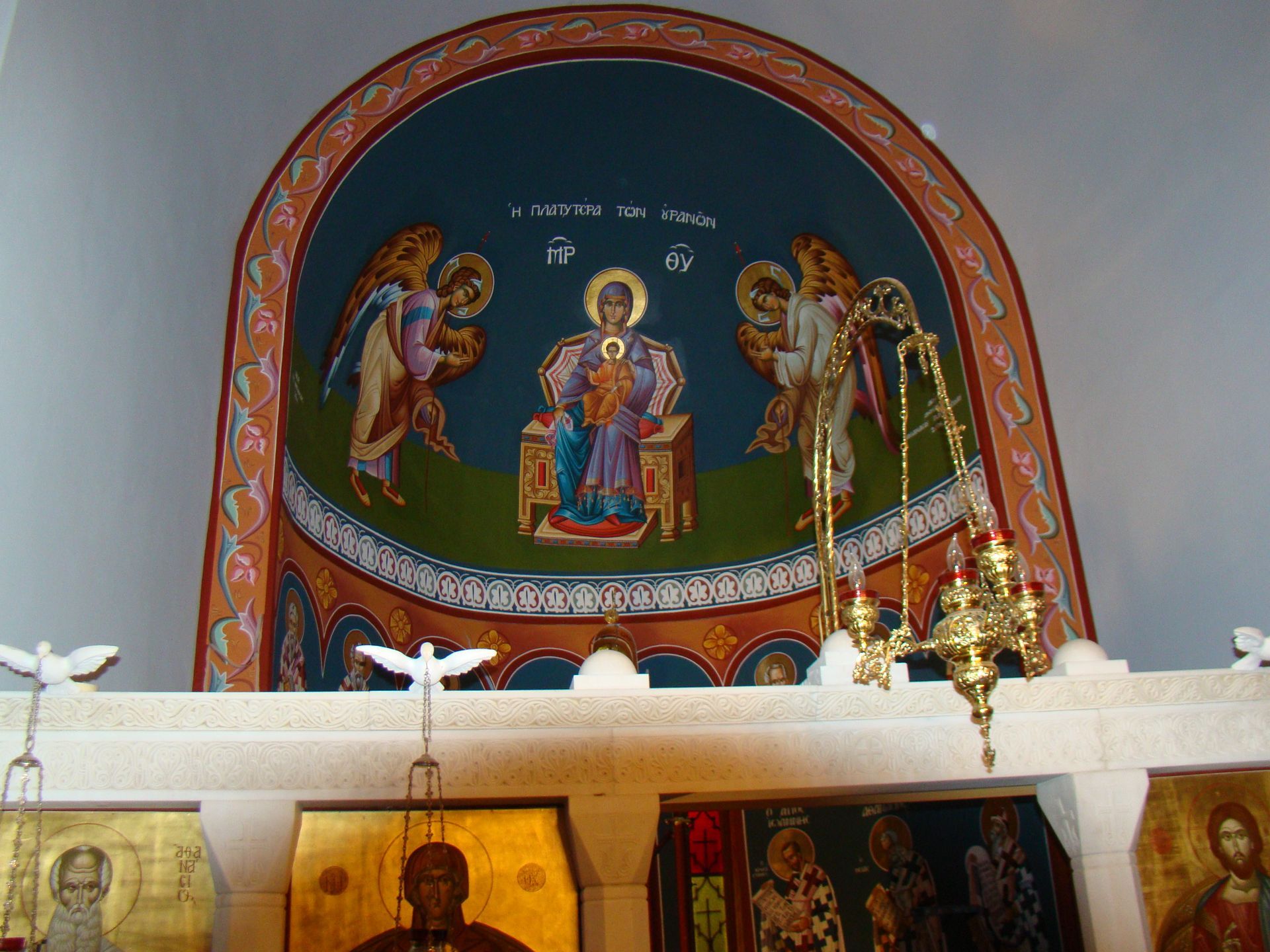 A painting of jesus surrounded by angels in a church