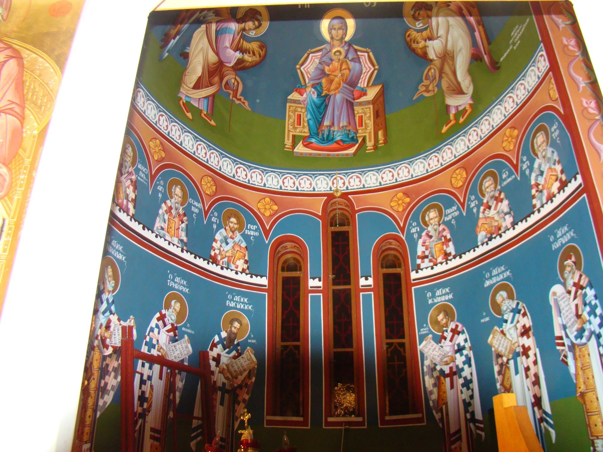 A painting of jesus sitting on a throne with angels around him