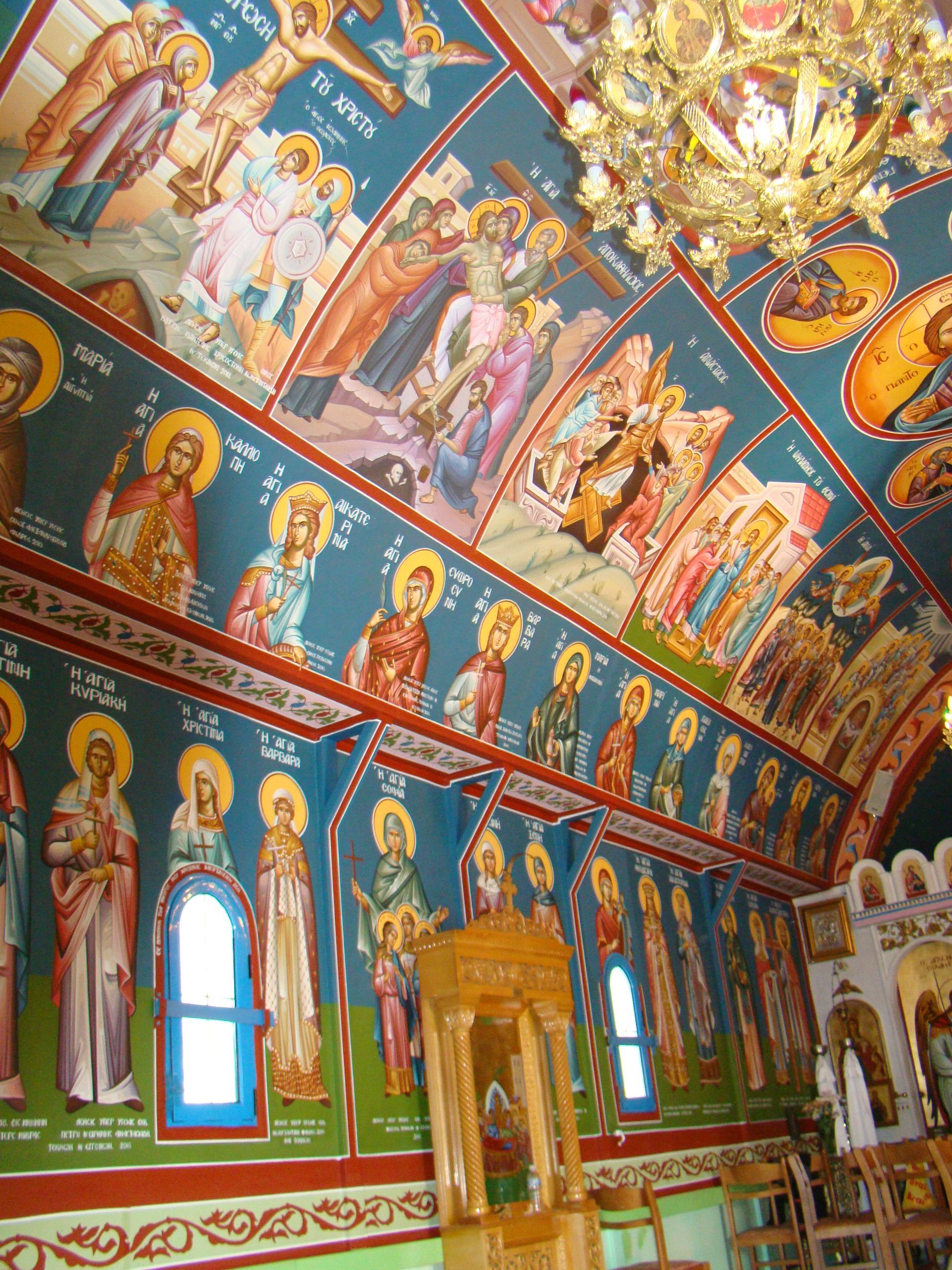 A church with a lot of paintings on the walls and ceiling