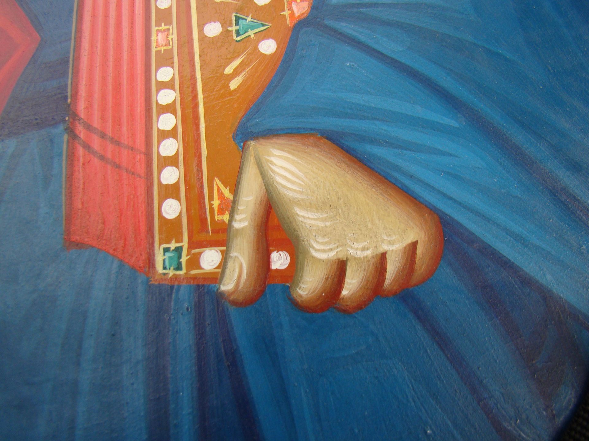 A close up of a painting of jesus holding a book