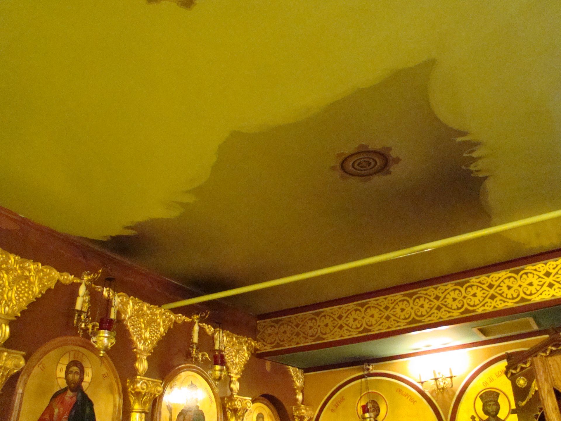 A shadow of jesus is cast on the ceiling of a church