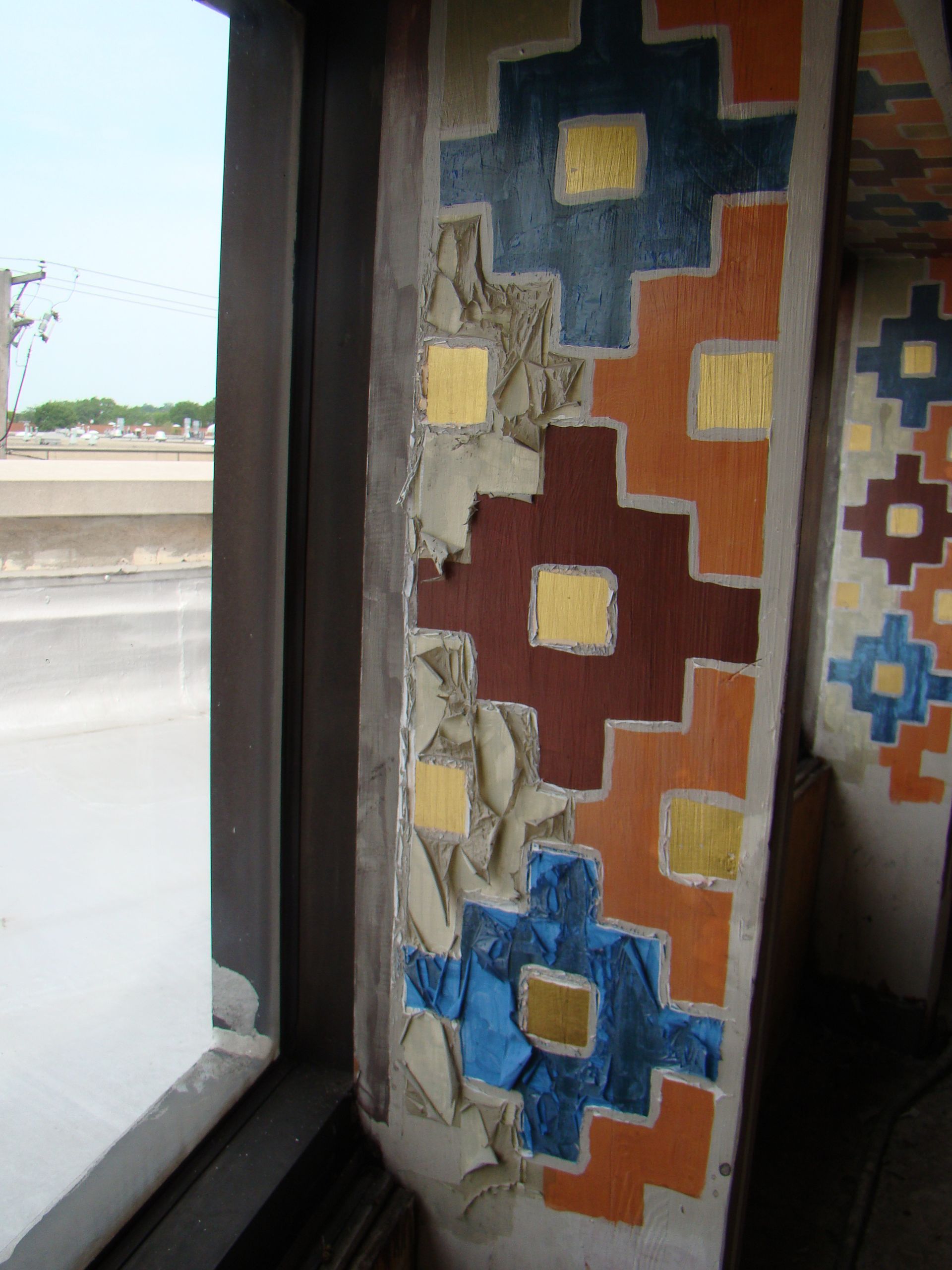 A wall with a geometric pattern painted on it