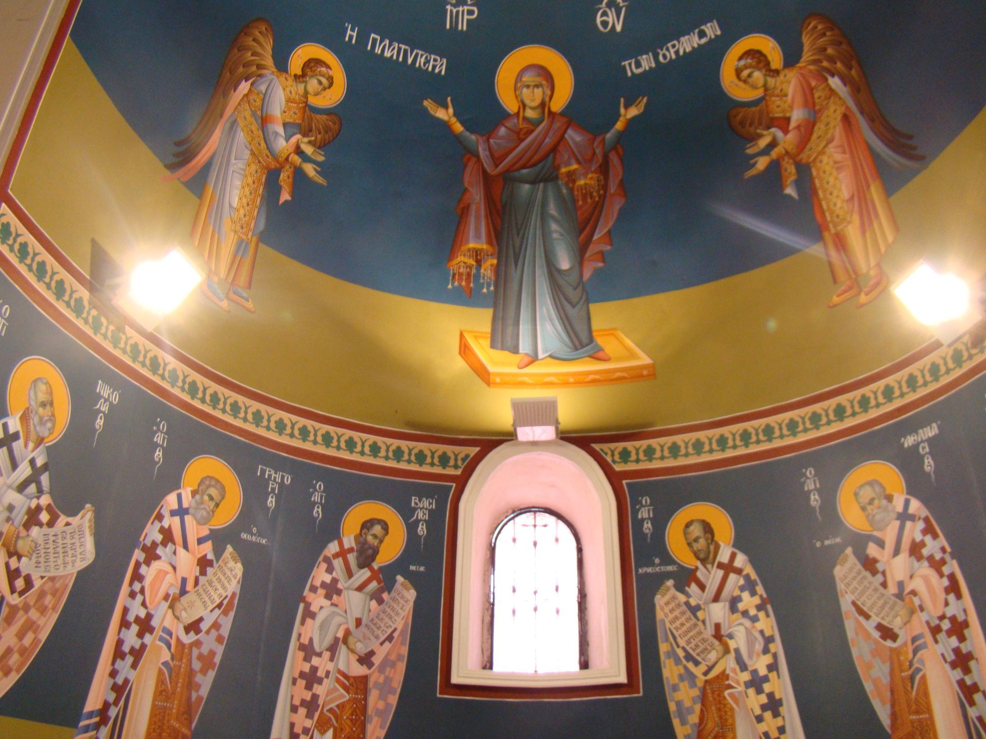A painting on the ceiling of a church shows angels and jesus