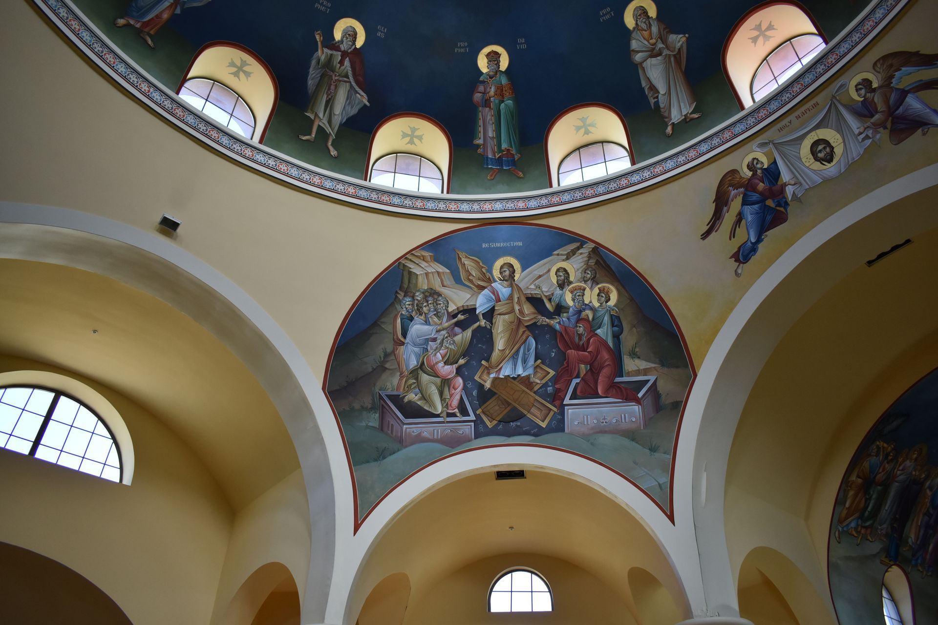 The inside of a church with a dome and paintings on the ceiling