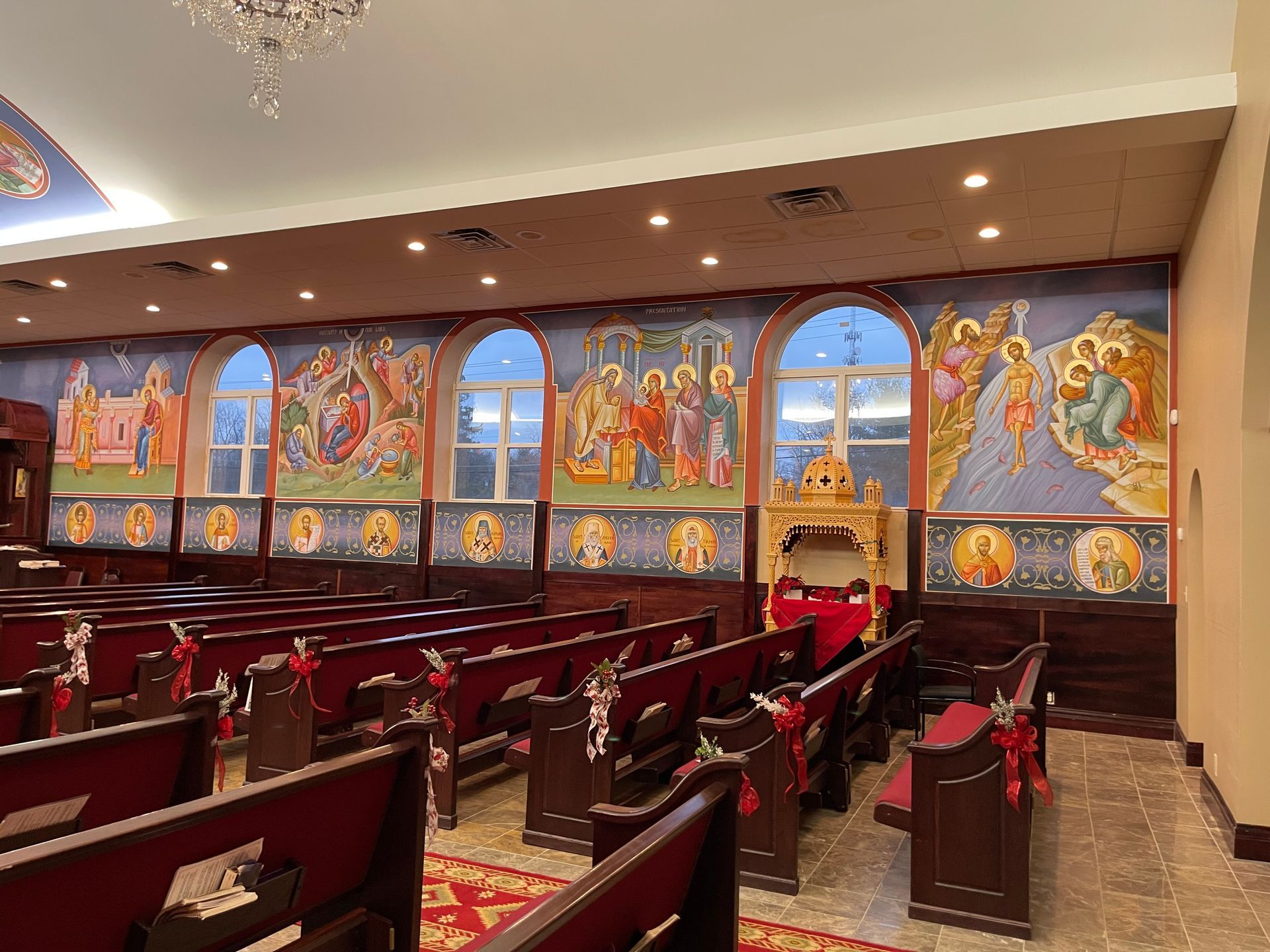 There is a large mural on the wall of the church.