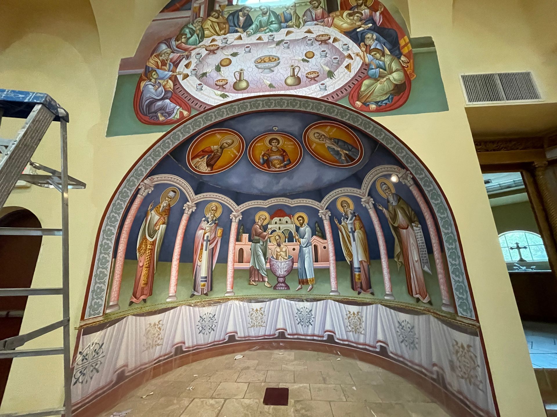 A painting on a wall with a ladder in the background