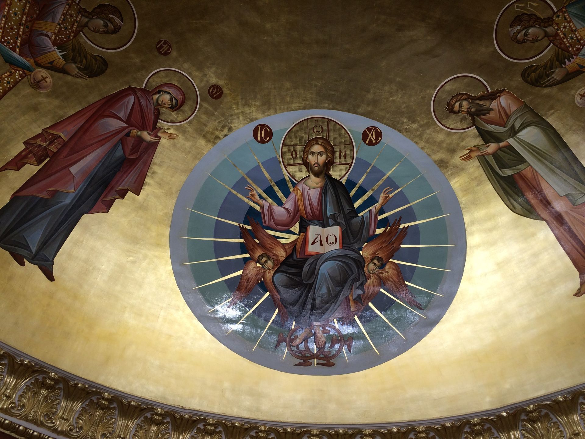 A painting of jesus in a circle with angels