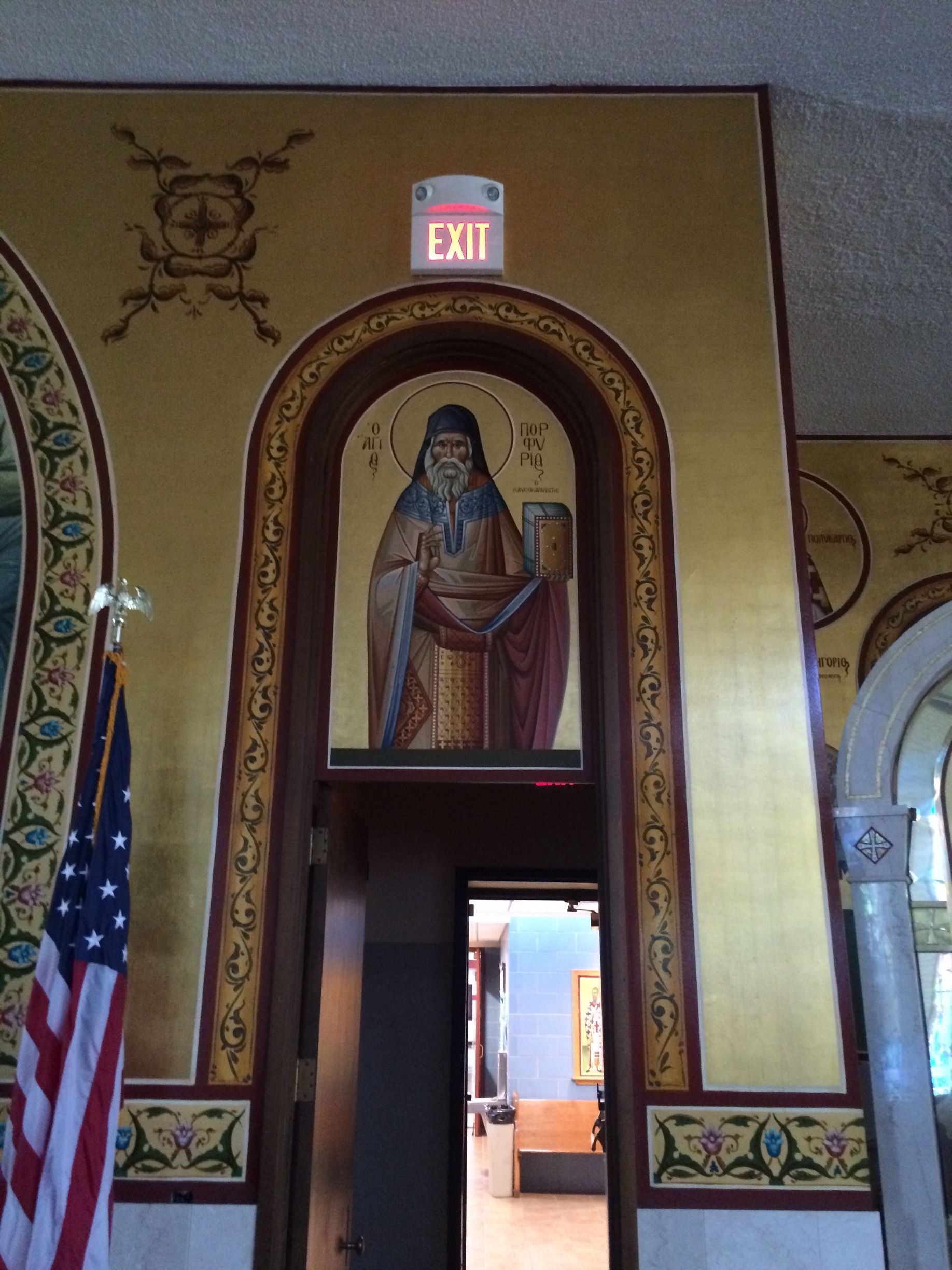 An exit sign is above a doorway in a church