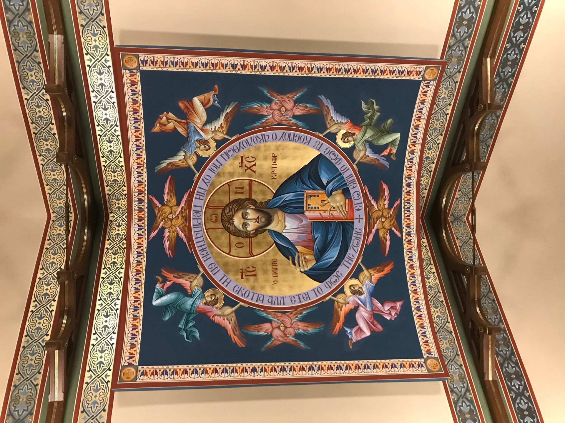 A painting of jesus and angels on the ceiling of a church