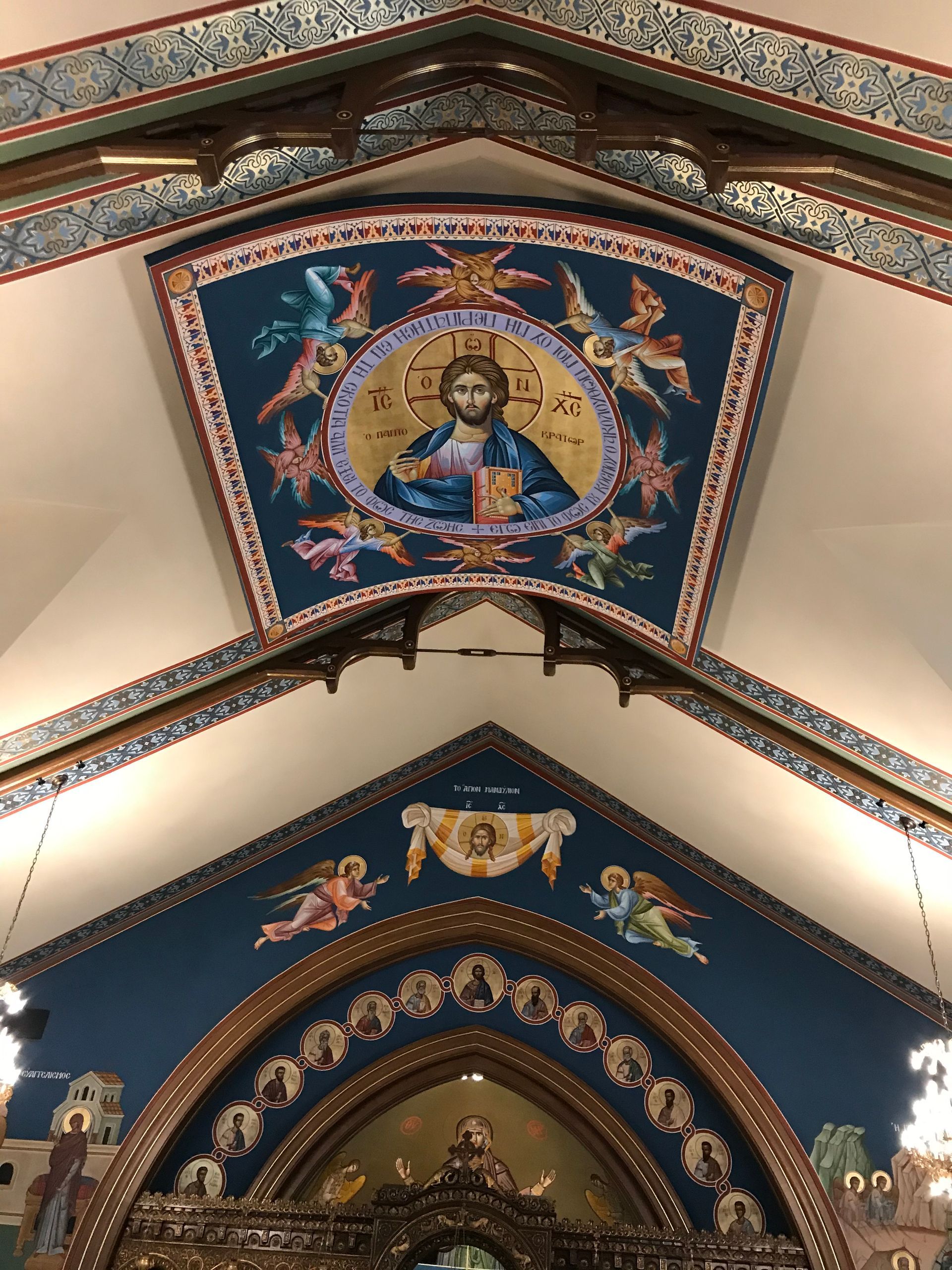 A painting of jesus on the ceiling of a church