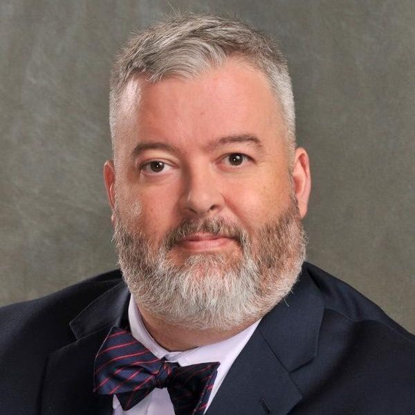 Man with graying beard and bow tie; formal portrait.