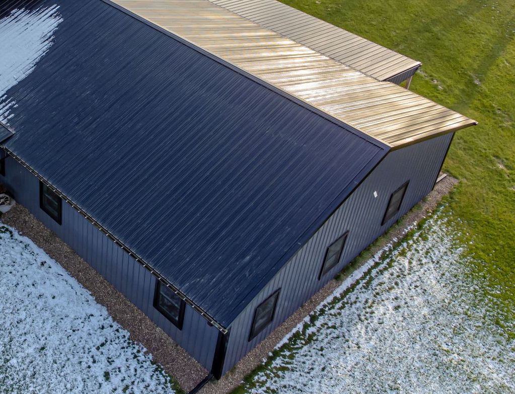 Black building with dark corrugated metal roof