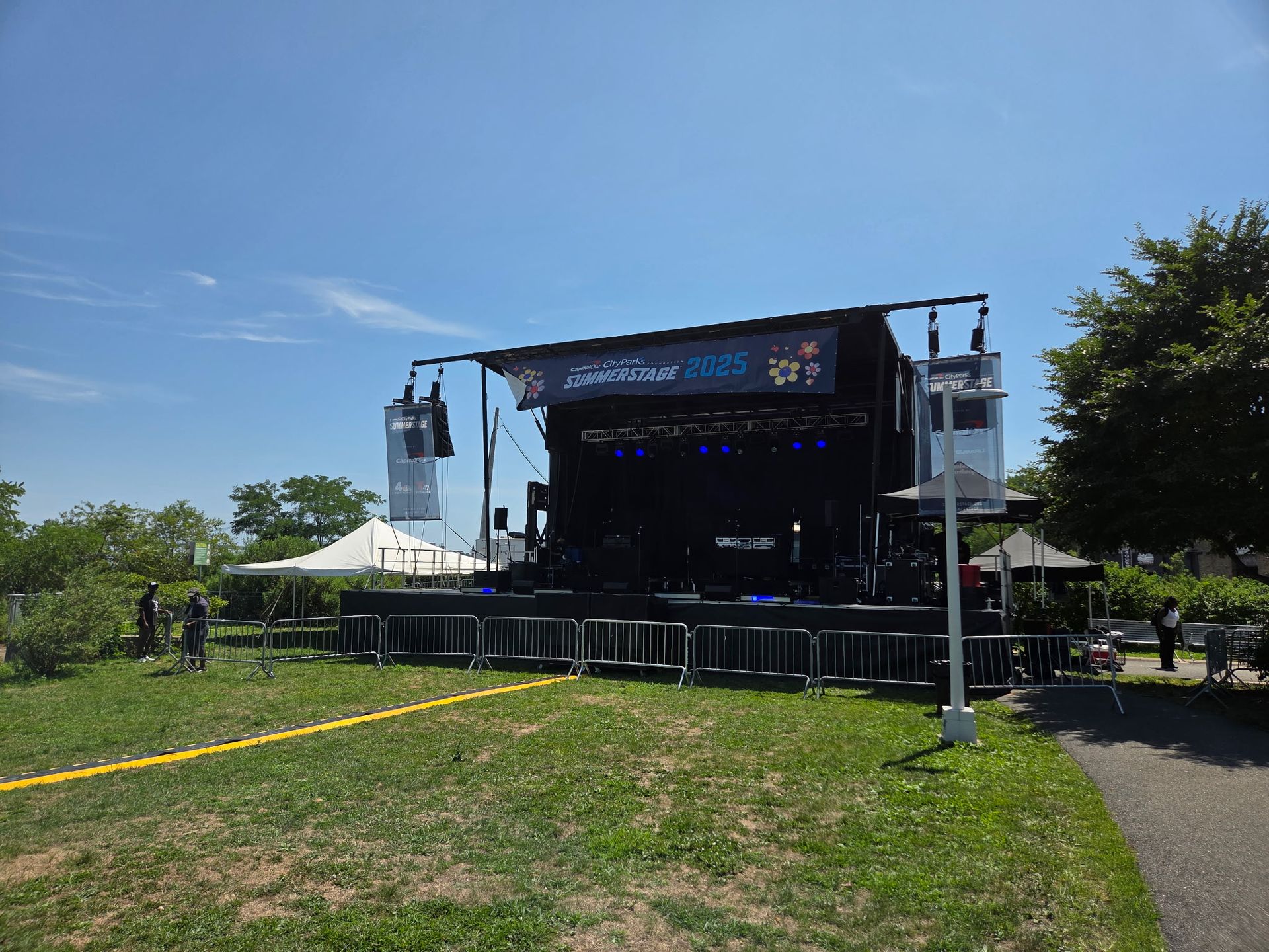 An outdoor concert stage with a banner reading 