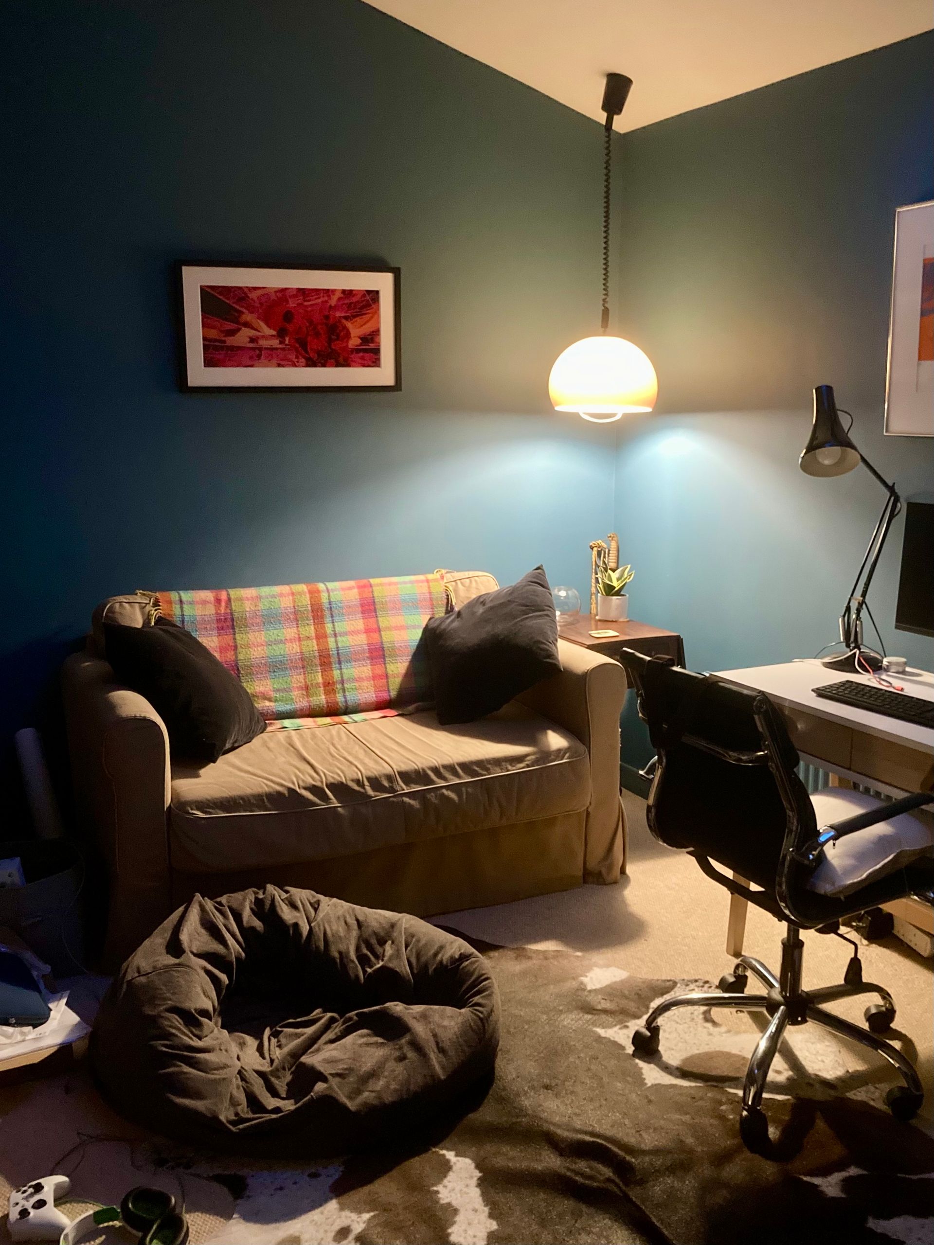 A living room with a couch , chair , desk and computer.
