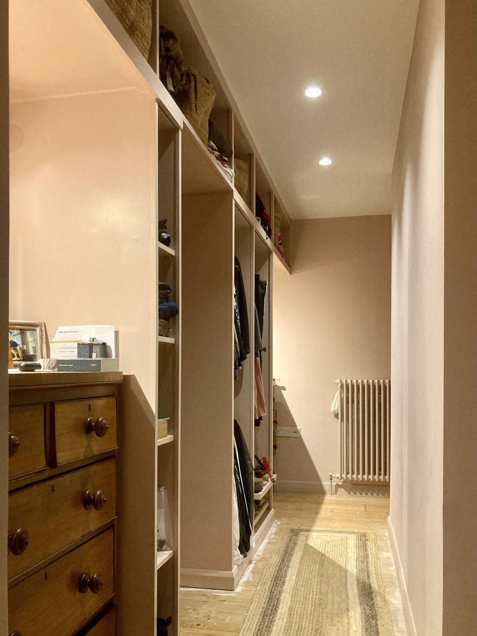 A long hallway with lots of shelves and drawers