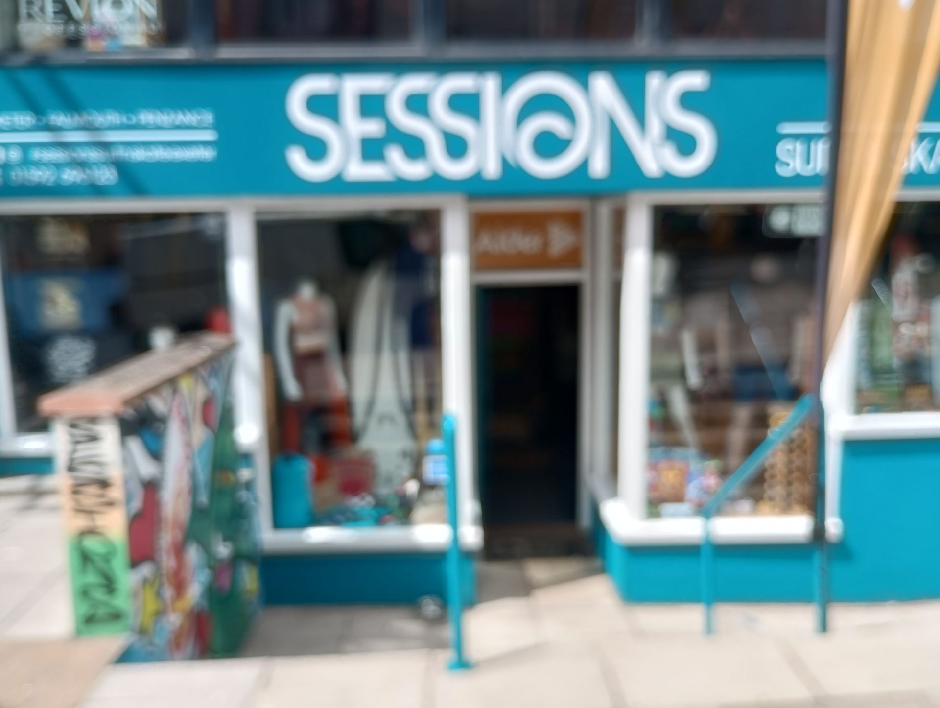A store front with a blue sign that says sessions