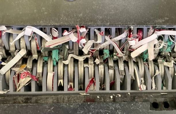 A paper shredder with pieces of shredded paper in the machine.