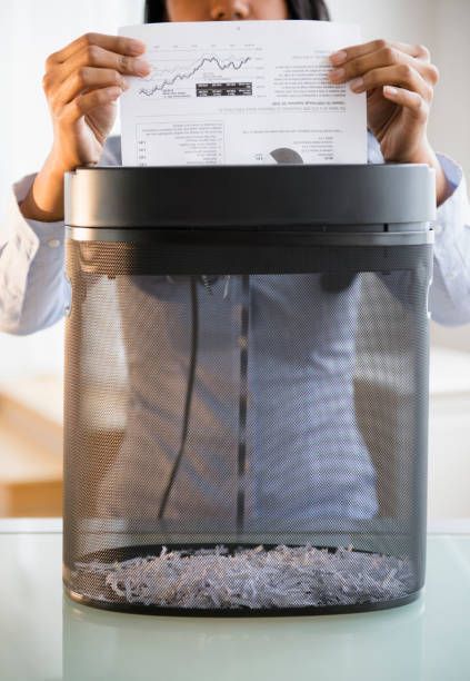 A woman is shredding documents.