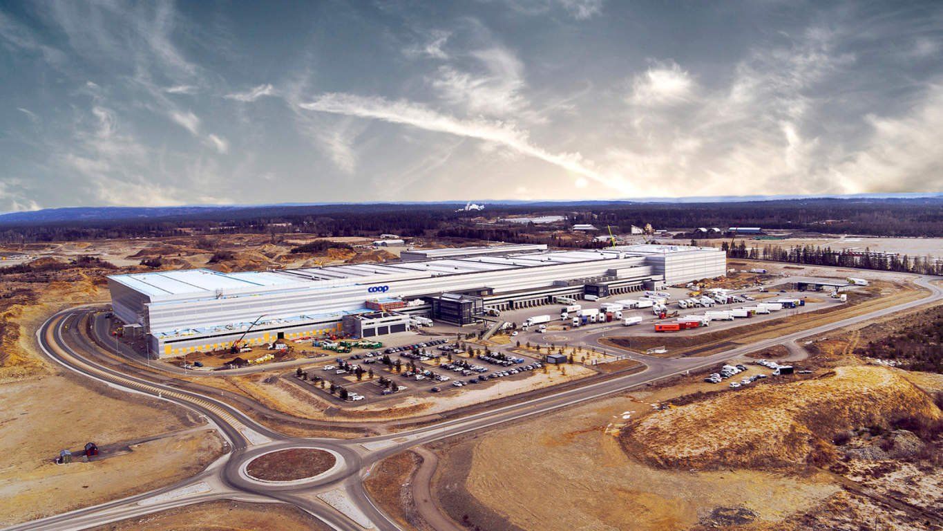 An aerial view of a large building with a roundabout in the middle