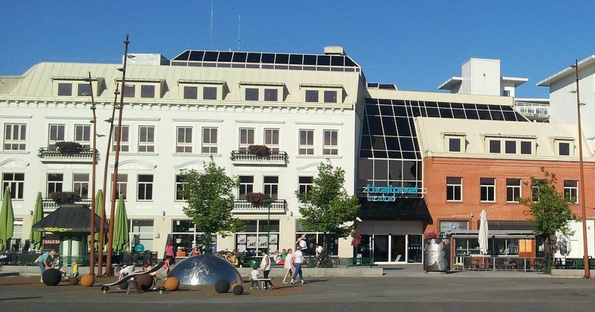 A large building with a blue sign that says ' emporio ' on it