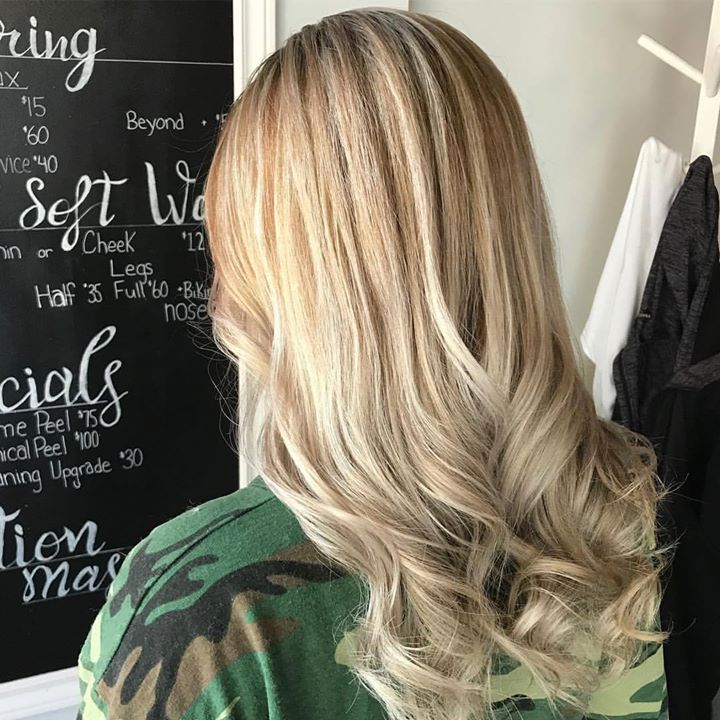A woman with blonde hair is standing in front of a blackboard that says specials
