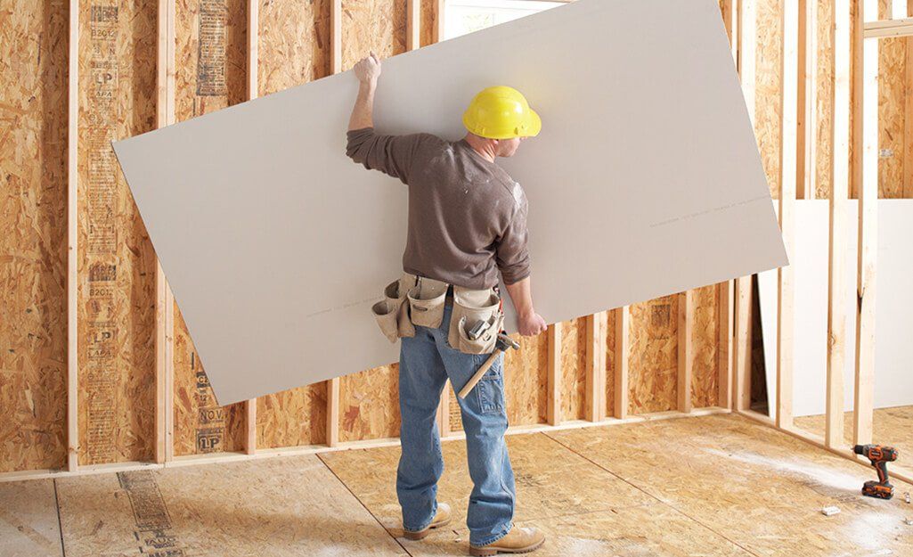 Construction man lifting a ply for walling