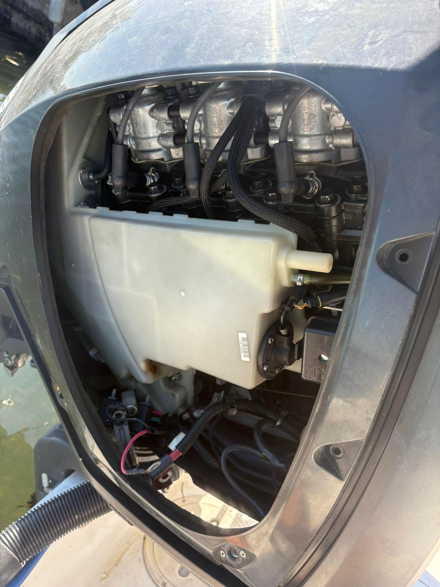 Close-up of a car headlight assembly with the cover removed, exposing internal wiring and components.