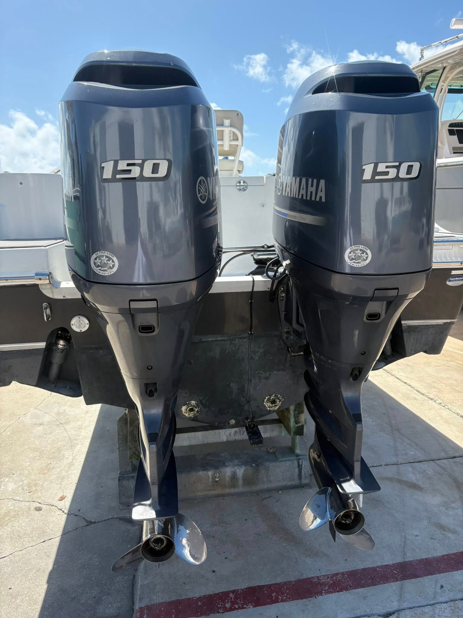 Two gray Yamaha 150 outboard motors mounted side by side on a boat transom.