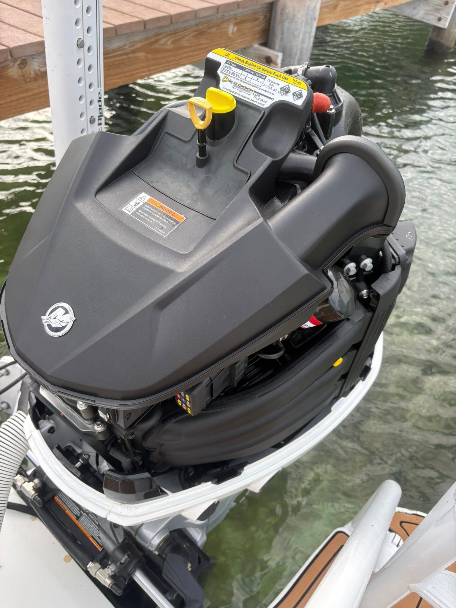 Black jet ski tied to a dock, viewed from above on the water