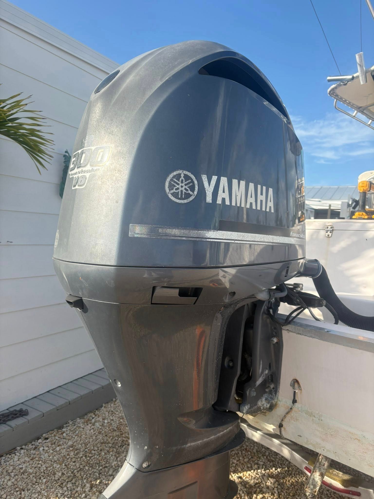 Gray Yamaha outboard motor mounted on a boat, viewed from the side outdoors.