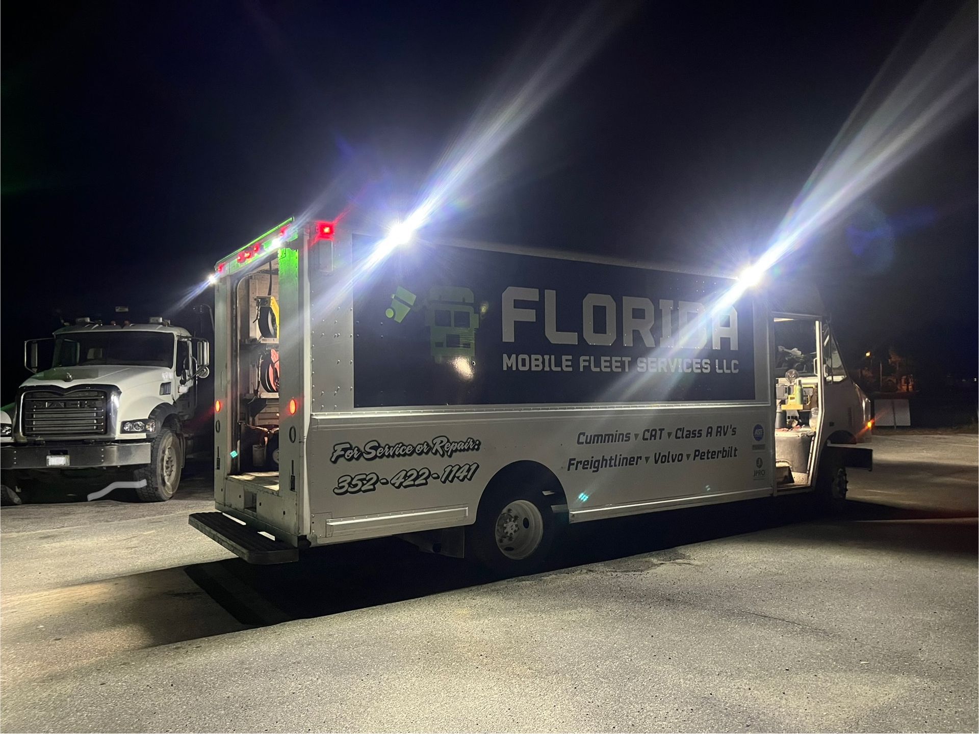A florida truck is parked in a parking lot at night.