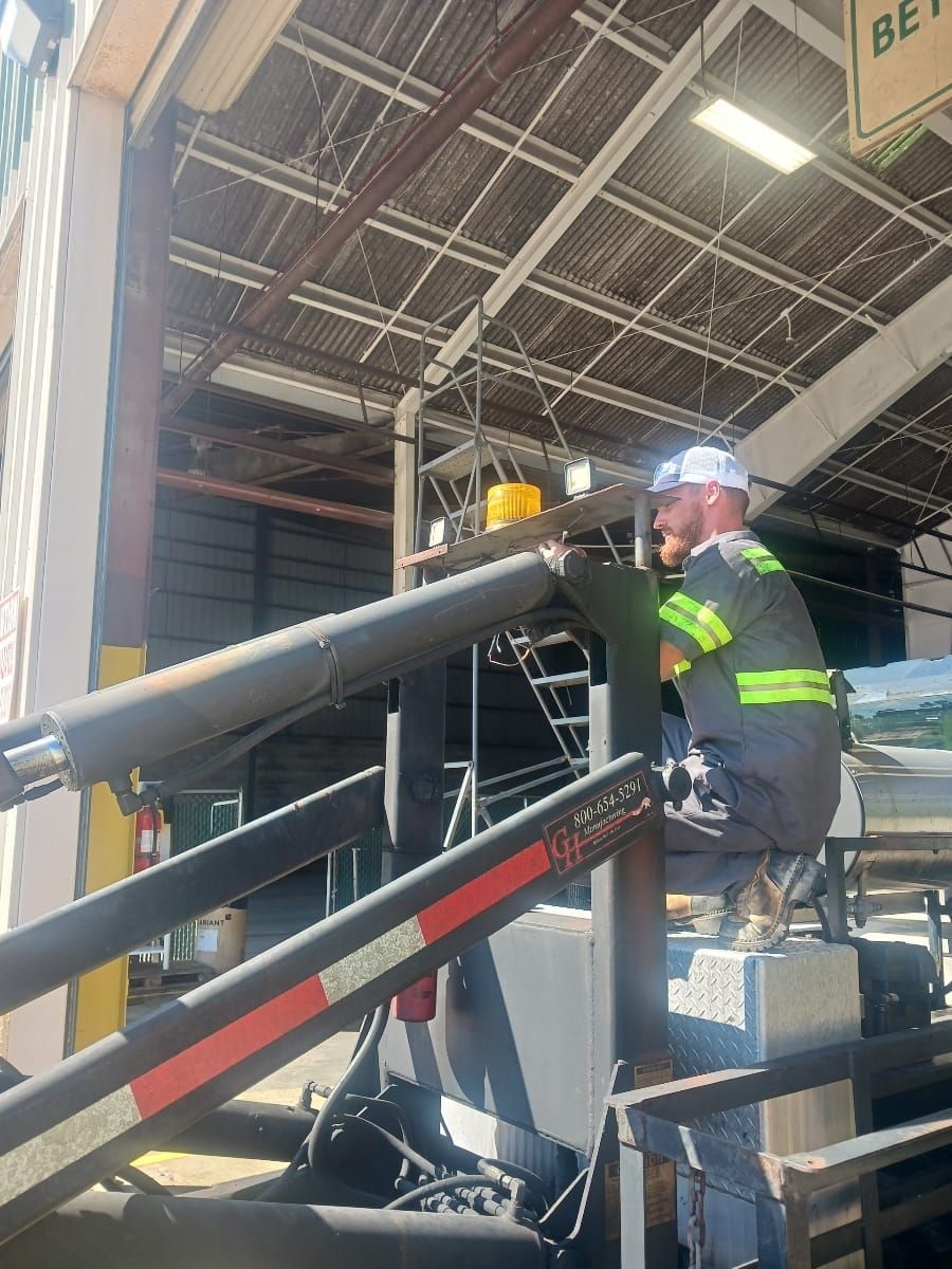 A man is working on a machine in a garage.
