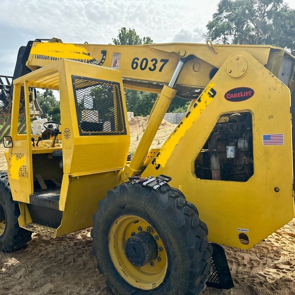 A yellow forklift with the number 6037 on it