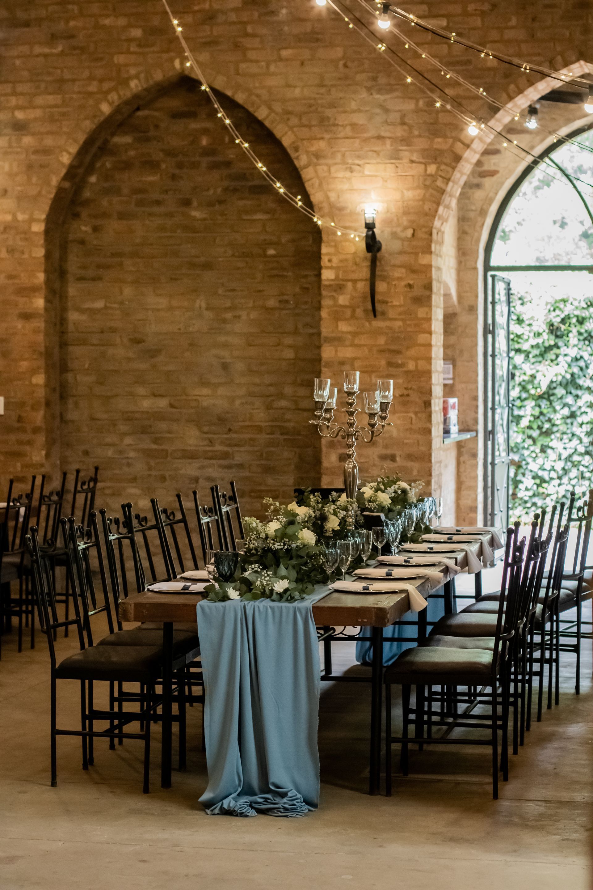 A long table with chairs and candles in the Main Reception Room at Riverside Castle, Gauteng's premier wedding venue.