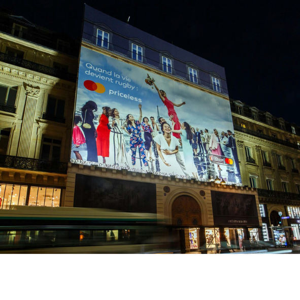 A large billboard on the side of a building advertising mastercard