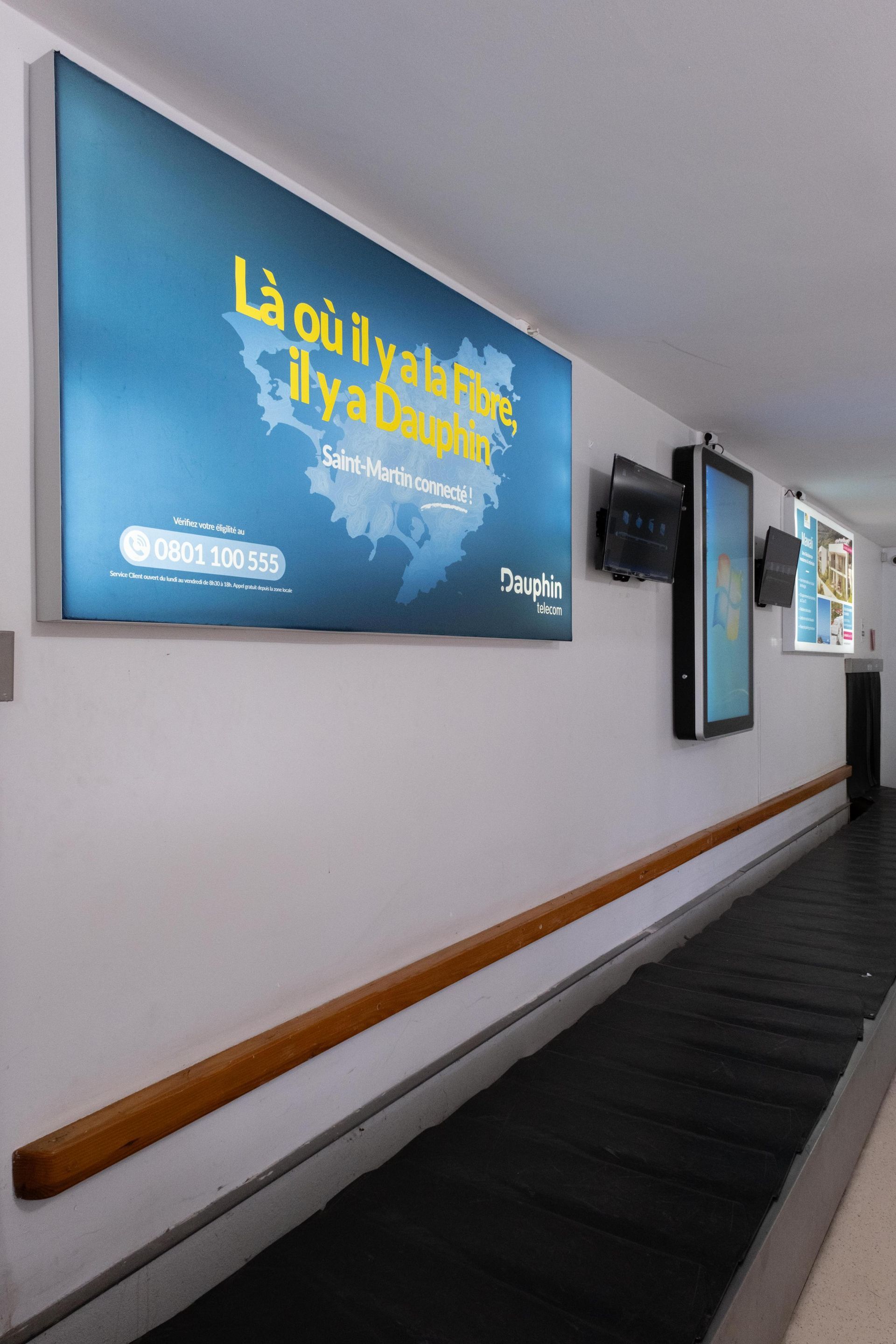 A long hallway with a sign on the wall that says