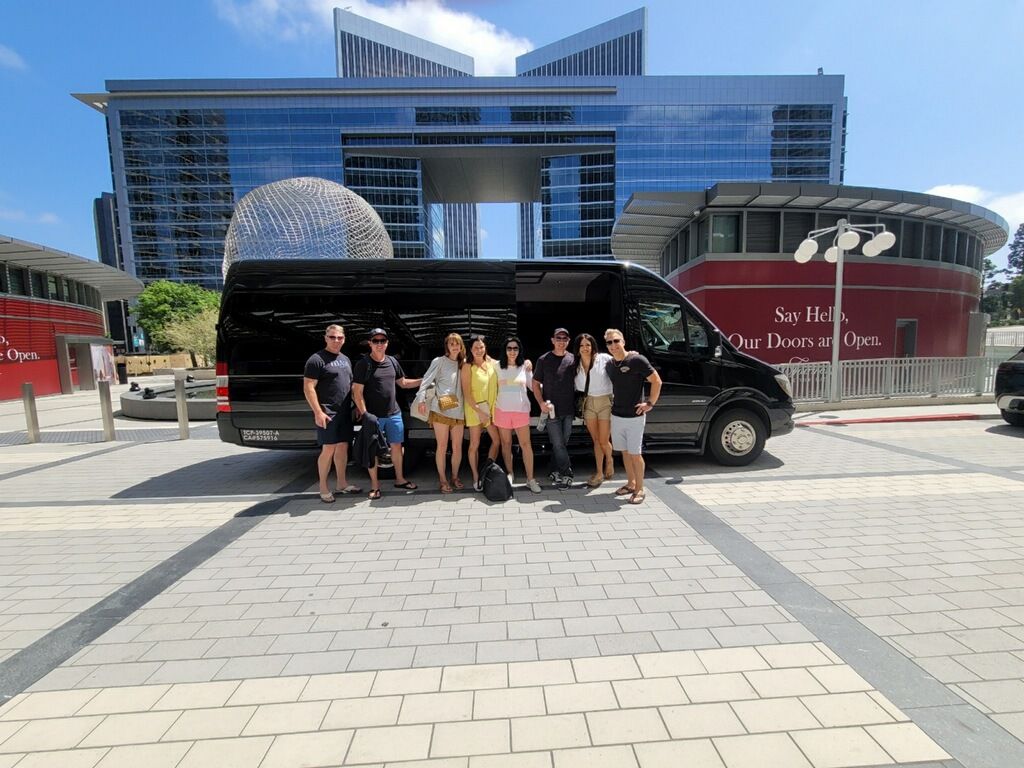 a group of people standing in front of a van