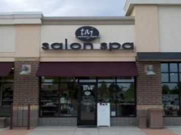 Salon spa storefront with a maroon awning and black trim.