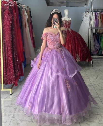 Mujer con un vestido de gala color lavanda con corpiño de cuentas y falda de volantes; escena de una tienda con vestidos.