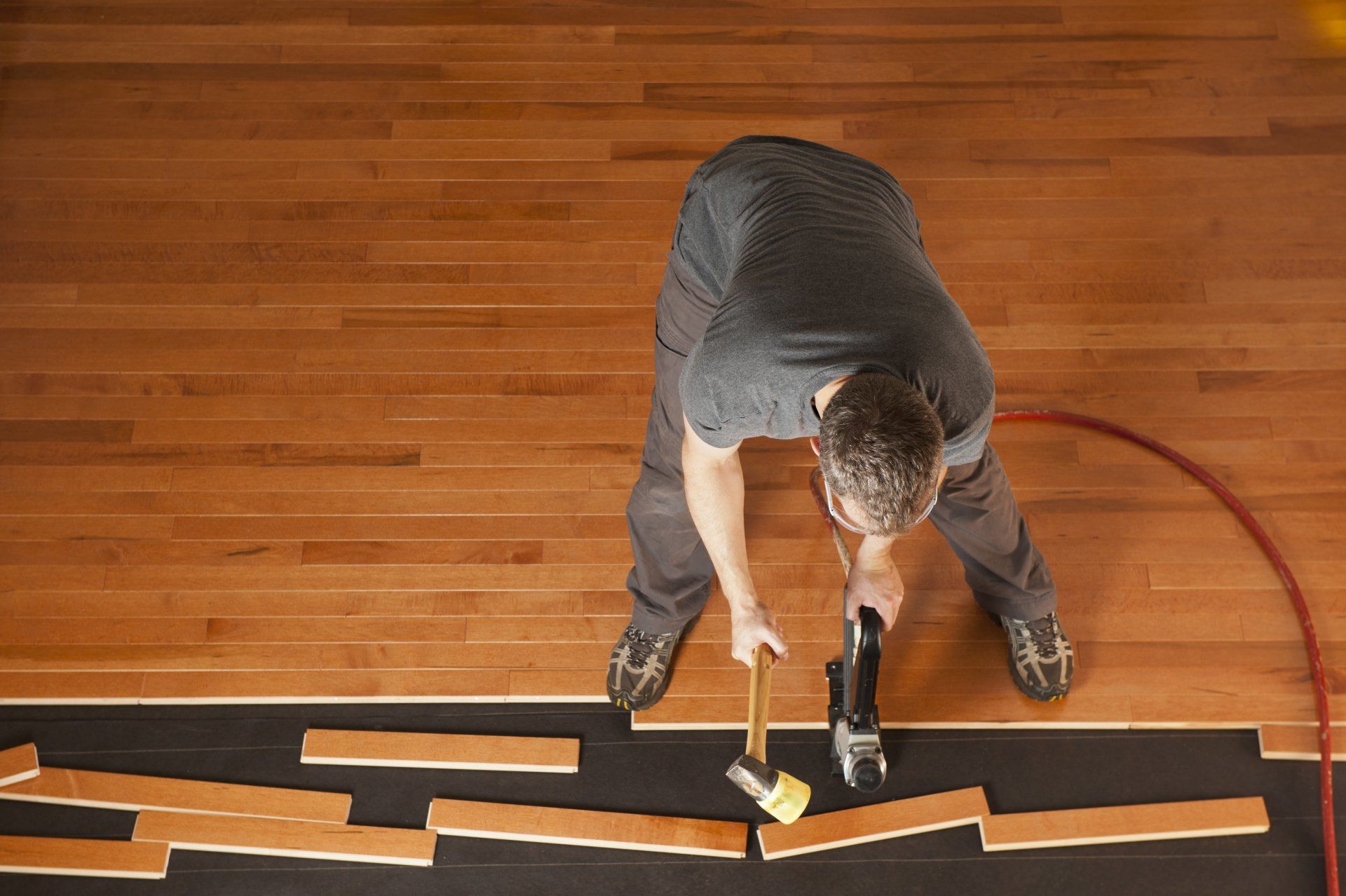 Engineered Hardwood Flooring — Man Working on Wood Flooring in Bellmawr, NJ