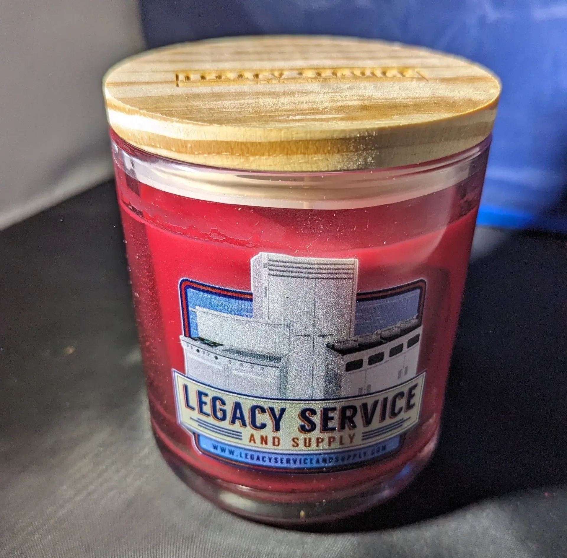 A legacy service and supply candle with a wooden lid.