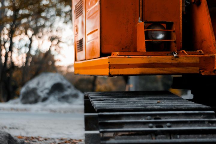 A close up of a bulldozer 's track on a construction site.