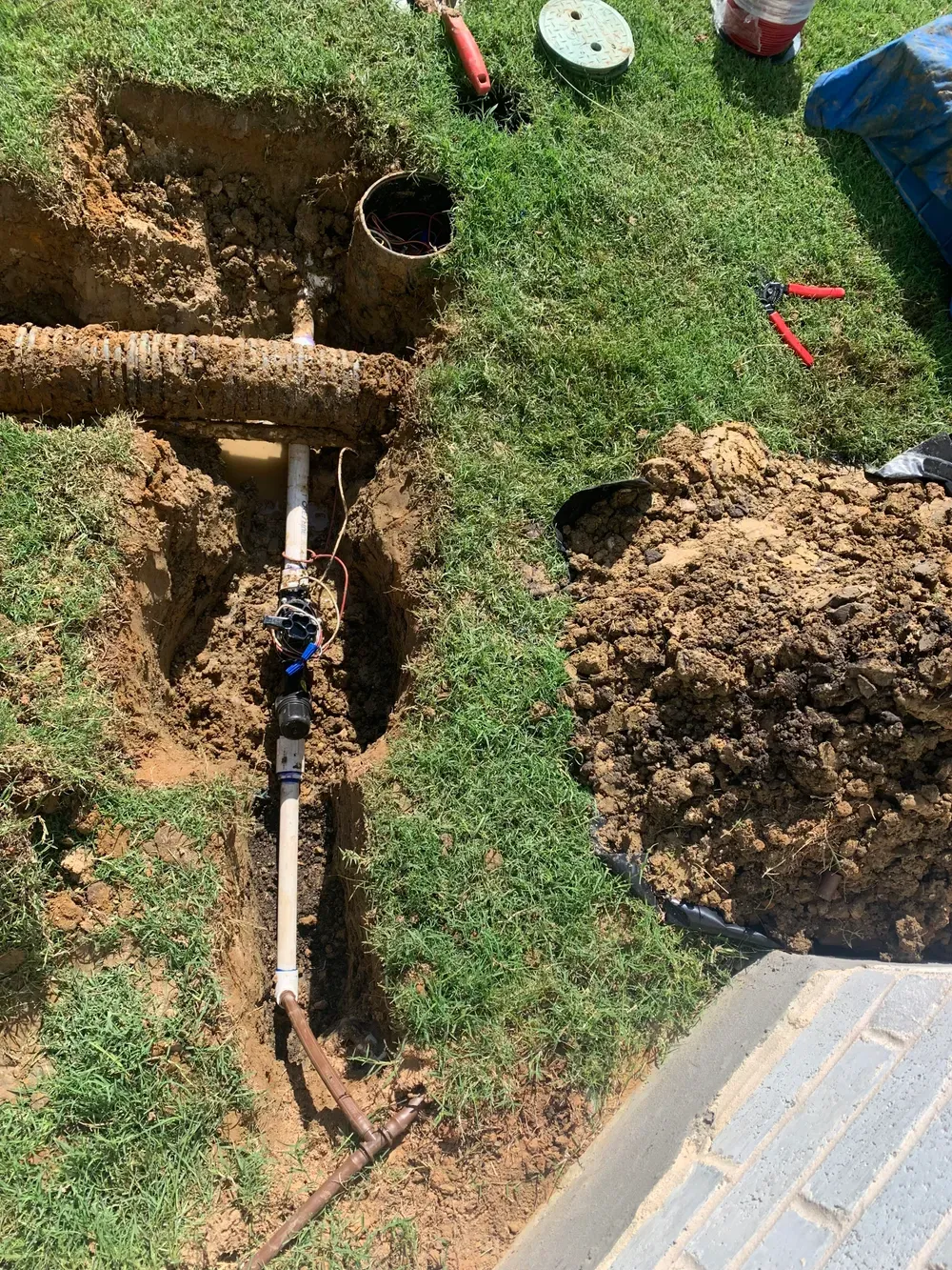 A pipe is being installed in a hole in the ground.