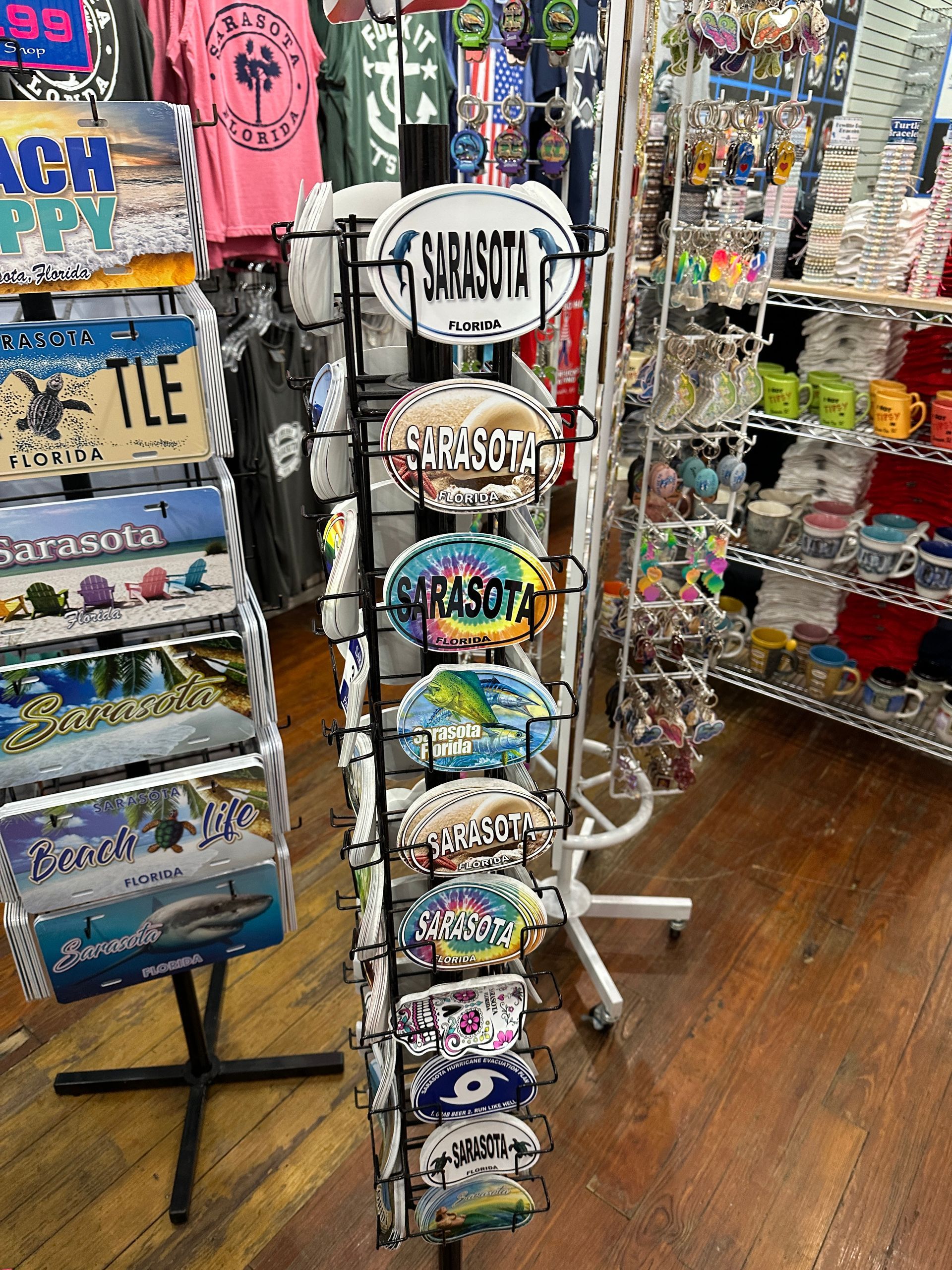 Souvenir shop display of license plates and postcards with various designs.