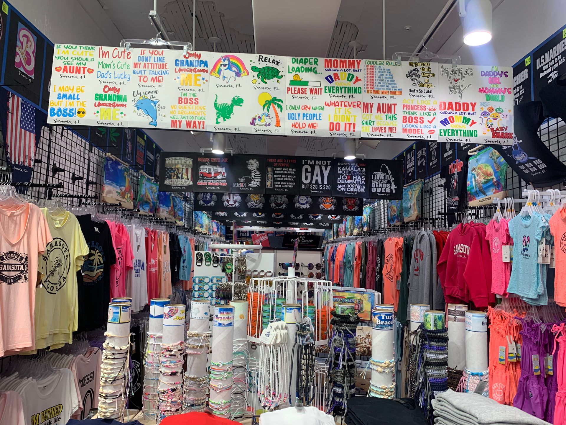 Inside a crowded souvenir shop filled with t-shirts, jewelry, and other items.