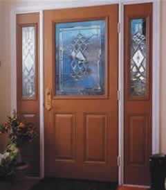Wooden front door with stained glass panel and sidelights.