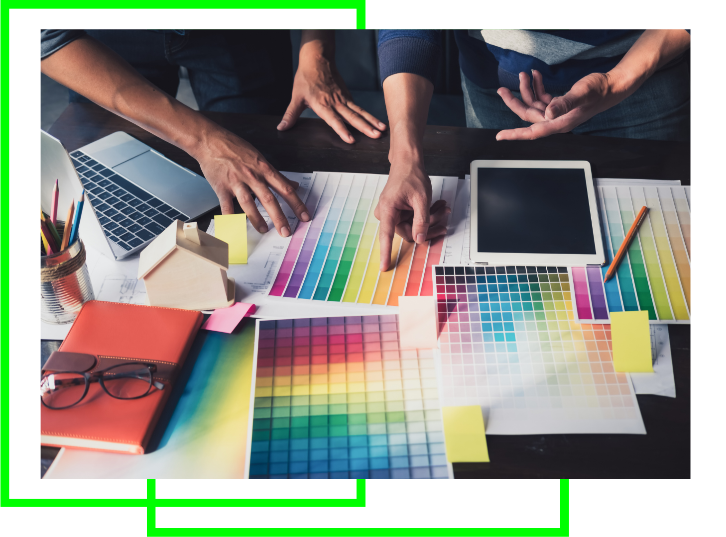 A group of people are sitting at a table looking at a color palette.