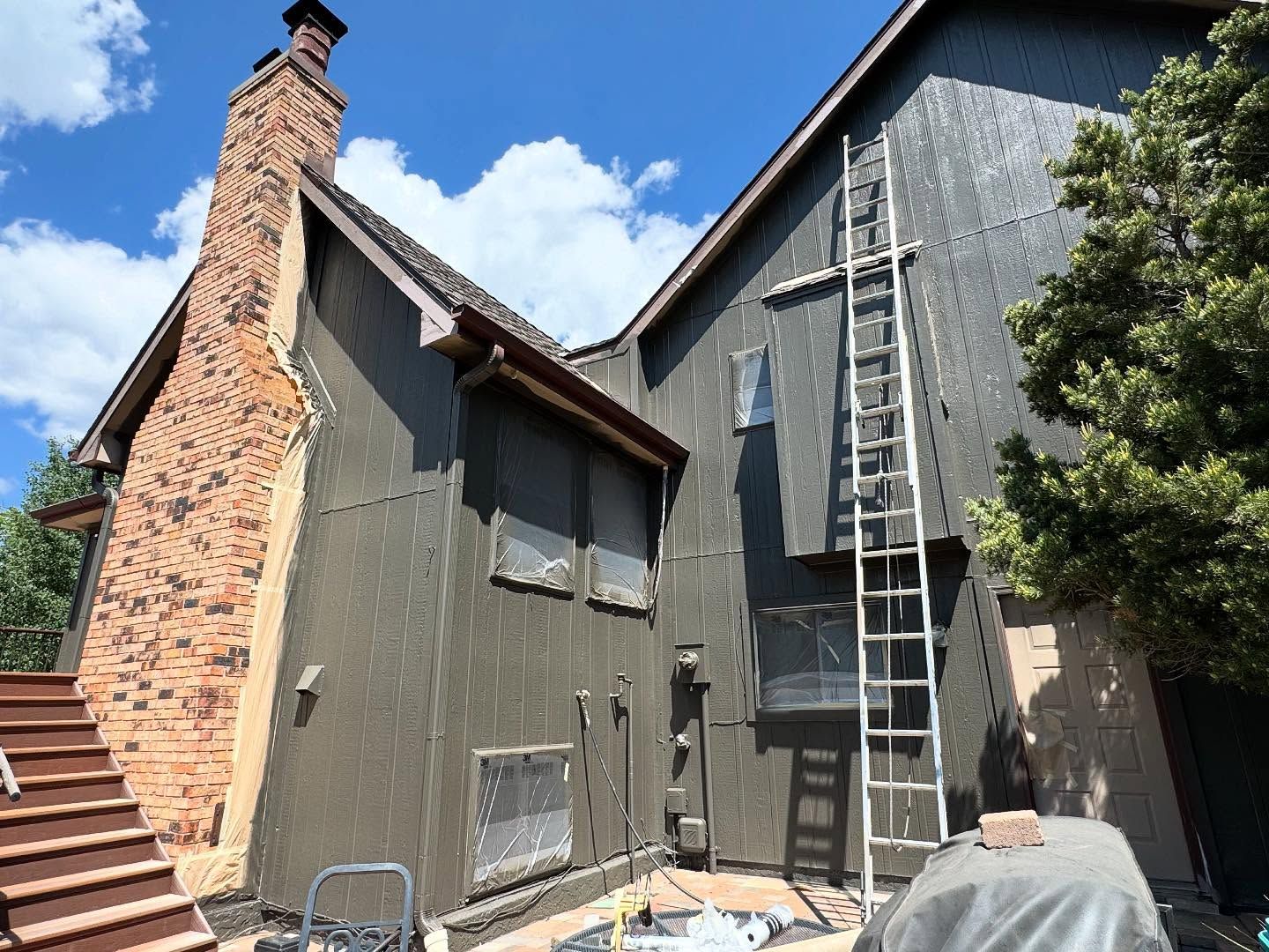 A large house with a ladder on the side of it.