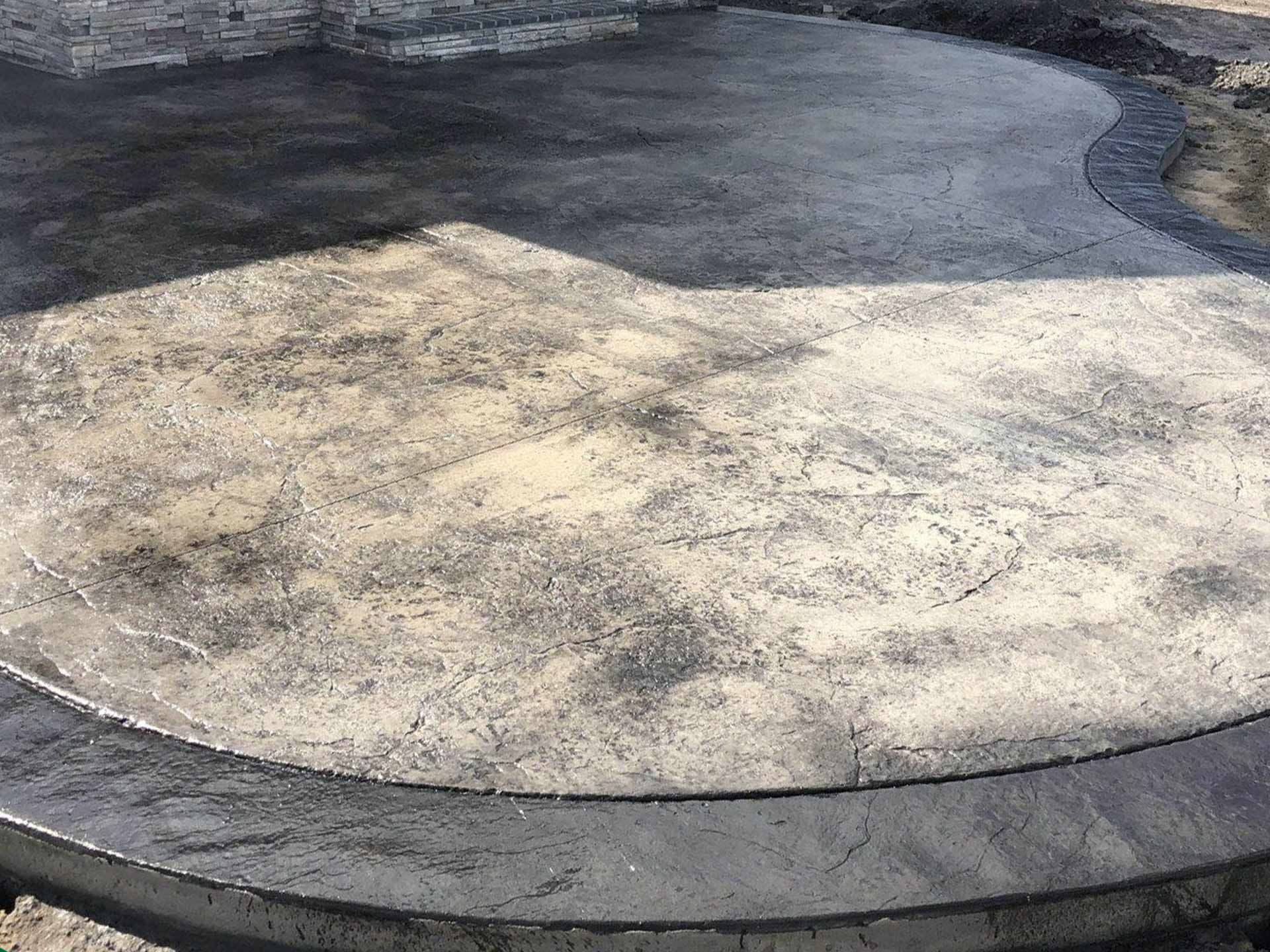 A close up of a concrete patio with a circle in the middle.