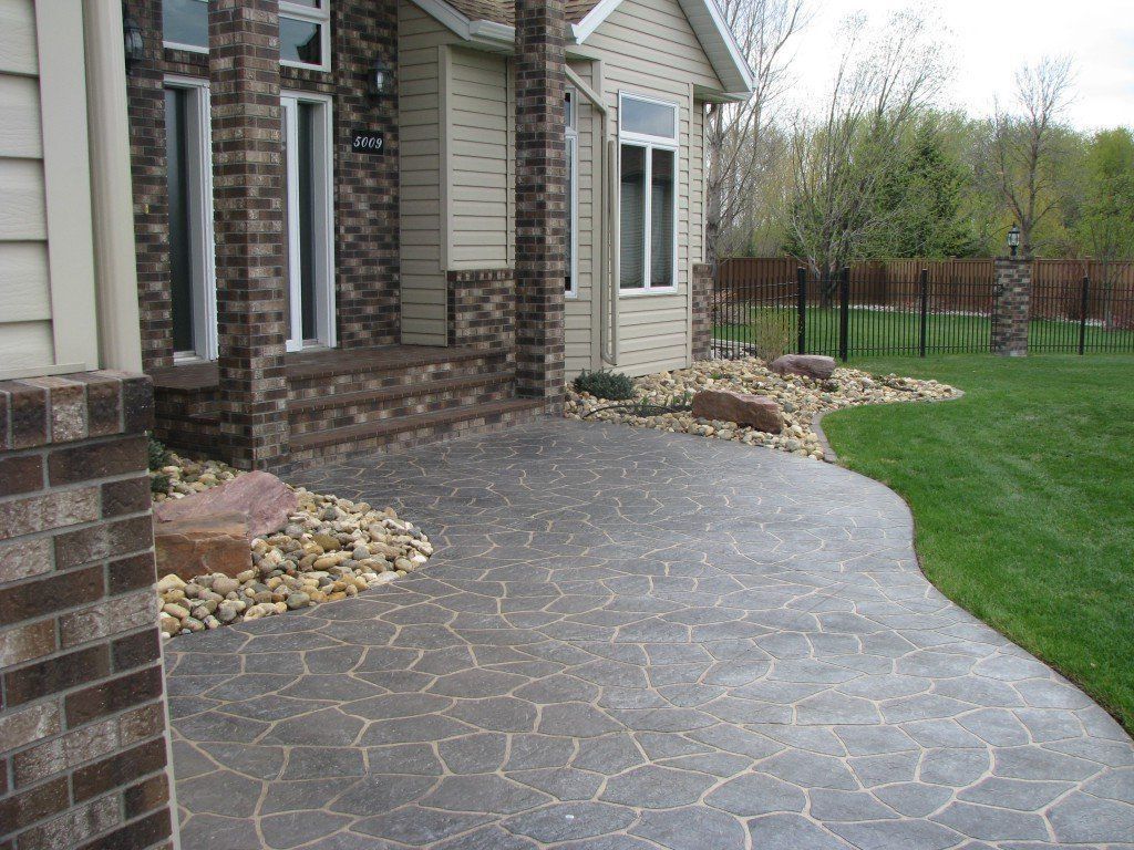 A brick house with a patio in front of it